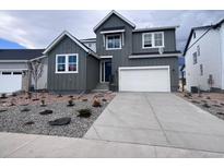 Modern two-story home featuring a two-car garage, complemented by professional landscaping for enhanced curb appeal at 4225 Ridgewalk Pt, Castle Rock, CO 80108