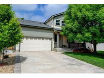 Charming home featuring a two-car garage, driveway, and mature landscaping enhancing its curb appeal at 7245 Prairie Cir, Longmont, CO 80504