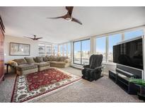 Spacious living room with city views, large windows, and comfortable seating at 1020 15Th St # 42C, Denver, CO 80202