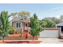 Charming single-story home featuring a manicured front yard, cozy entrance, and attached garage, offering curb appeal at 1025 E Iowa Ave, Denver, CO 80210