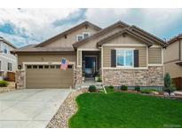 Charming single-Gathering home with a well-manicured lawn, stone accents, and a two-car attached garage at 14116 Double Dutch Cir, Parker, CO 80134
