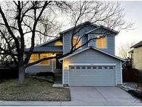 Charming two-story home with an attached two-car garage and mature trees in front yard at 9057 Bermuda Run Cir, Highlands Ranch, CO 80130