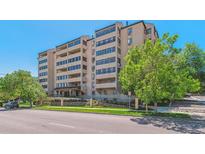 Multi-story condo with several balconies, mature trees, and street view at 7420 E Quincy Ave # 304, Denver, CO 80237