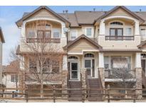 Inviting two-story townhome featuring a charming covered porch and neutral color palette in a desirable neighborhood at 1396 Royal Troon Dr, Castle Rock, CO 80104