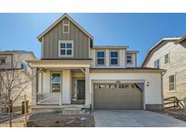 Charming two-story home featuring a welcoming front porch and an attached two-car garage at 5546 Inland Ave, Firestone, CO 80504