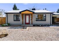 Charming one-story home with a minimalist rock yard, red door, and natural wood entry covering at 5362 S Cedar St, Littleton, CO 80120