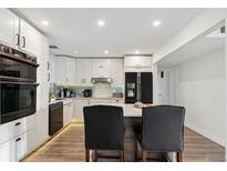 Modern kitchen features stainless steel appliances and white cabinetry at 1056 Tucson St, Aurora, CO 80011