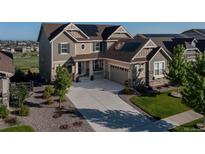 Beautiful home exterior with solar panels, manicured lawn and long driveway at 8761 S Wenatchee Ct, Aurora, CO 80016
