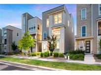 Contemporary home with clean lines, gray and white facade, professional landscaping, and inviting entrance at 12261 Farmview St, Thornton, CO 80241