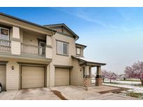 Inviting townhome with attached garages, stone accents, and manicured landscaping, offering convenience and curb appeal at 12914 Grant Cir # C, Thornton, CO 80241