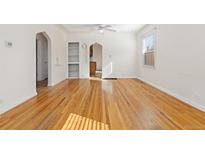 Spacious living room with hardwood floors, built in shelving, ceiling fan and lots of natural light at 3130 S Washington St, Englewood, CO 80113