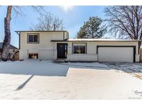 Charming two-story home featuring an attached two-car garage and snow covered front yard at 3930 Jackson Way, Thornton, CO 80233