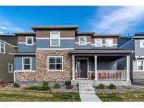 Charming two-story home with stone accents and a welcoming front porch at 16544 E 118Th Dr, Commerce City, CO 80022