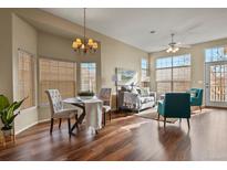 Bright and spacious living room area with hardwood floors, complemented by neutral tones and natural light at 3950 E 127Th Ave, Thornton, CO 80241