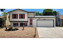 Charming two-story home featuring red shutters, a well-kept lawn, and an attached two-car garage at 19630 E Purdue Pl, Aurora, CO 80013