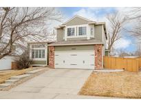 Charming two-story home featuring a brick-accented garage and well-maintained front yard at 10063 Silver Maple Rd, Highlands Ranch, CO 80129