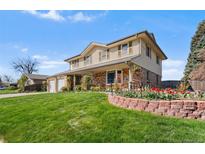Beautiful two-story home with brick and siding exterior, landscaped yard and a two car garage at 3191 S Holly Pl, Denver, CO 80222