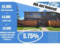 Two-story townhome with brick and siding exterior, wooden fence, and HOA benefits at 8039 Wolff St # E, Westminster, CO 80031
