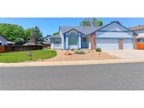 Charming single-Gathering home featuring a well-manicured front yard and a two-car garage at 12935 Lake Circle Dr, Thornton, CO 80241
