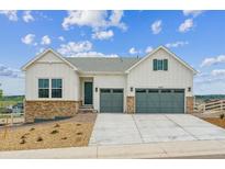 Beautiful two-story home with a brick facade and two-car garage, complemented by a well-manicured lawn at 4978 Hickory Oaks St, Castle Rock, CO 80104