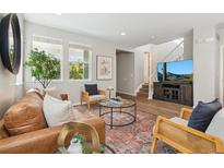 Inviting living room with hardwood floors and a comfortable seating arrangement at 3178 Geneva Ct, Denver, CO 80238