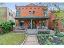 Charming brick home featuring a welcoming front porch and well-maintained landscaping, perfect for relaxing outdoors at 39 S Grant St, Denver, CO 80209