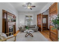 Bright living room with a decorative fireplace, hardwood floors, and natural light at 39 S Grant St, Denver, CO 80209