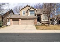 Two-story home featuring a three-car garage and well-manicured front lawn at 6786 Silverleaf Ave, Firestone, CO 80504