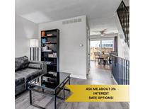 Cozy living room featuring modern furnishings and hardwood floors that lead to the dining area at 8905 Field St # 91, Westminster, CO 80021