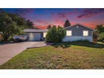Charming single-story home with well-maintained lawn and driveway; perfect for Gathering living at 7780 S Kendall Blvd, Littleton, CO 80128