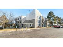 Condo building exterior showcasing ample parking and landscaping at 1383 W 88Th Ave # 307, Thornton, CO 80260