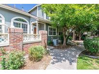 Townhouse exterior with landscaping and walkway at 2960 W Long Dr # E, Littleton, CO 80120