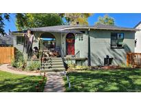 Charming bungalow with a welcoming front porch and well-maintained landscaping at 1303 Newport St, Denver, CO 80220