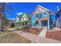 Charming street view showcasing colorful, well-maintained Victorian-style homes under a clear blue sky at 169 W Byers Pl, Denver, CO 80223