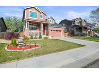 Charming two-story home featuring a well-manicured front yard and attached garage with a brick and siding facade at 11373 Kearney Way, Thornton, CO 80233