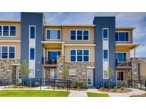 Modern townhome featuring stone accents, multiple windows, and private balconies at 6737 S Tempe Ct, Aurora, CO 80016