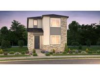 Two-story home with stone accents, neutral siding, manicured landscaping and a cozy front entry at 21166 E 62Nd Dr, Aurora, CO 80019