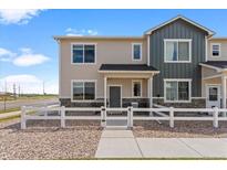Charming townhome with fenced front yard and covered porch, perfect for relaxing outdoors at 503 S Rollie Ave # 12D, Fort Lupton, CO 80621