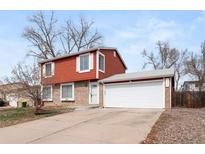 Charming two-story home with a two car garage, brick and siding and mature trees at 10433 W Patterson Pl, Littleton, CO 80127