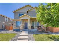 Charming two-story home featuring stone accents, a welcoming front porch, and professionally landscaped yard at 11709 Park South Ln, Parker, CO 80138
