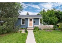 Charming blue single-story home with well-maintained lawn, walkway, and inviting, peach-colored front door at 3175 S Pennsylvania St, Englewood, CO 80113