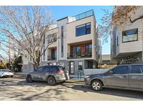 Modern townhome featuring a sleek design with balconies and a rooftop terrace on a sunny day at 3814 Zenobia St, Denver, CO 80212