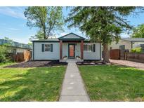 Charming home featuring a well-manicured lawn and inviting walkway at 2080 Fulton St, Aurora, CO 80010