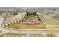 Expansive aerial view showcases the property's open land, horse area, mature trees and proximity to neighborhood at 12940 W 75Th Ave, Arvada, CO 80005