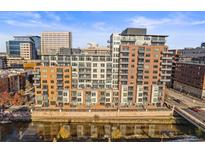 Multi-story condominium building featuring balconies overlooking the river with city views at 1401 Wewatta St # 911, Denver, CO 80202