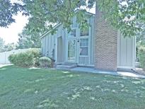 Charming home exterior featuring a well-maintained lawn and inviting entrance and brickwork at 9669 W Chatfield Ave # A, Littleton, CO 80128