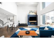 Bright, open living room boasts fireplace feature wall and modern furnishings at 1581 King St, Denver, CO 80204