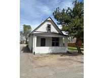 Charming two-story home featuring a covered porch and large front yard at 4582 N Shoshone St, Denver, CO 80211
