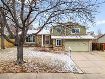 Charming two-story home with brick accents, a two-car garage, and a well-maintained front yard at 3293 S Fairplay St, Aurora, CO 80014
