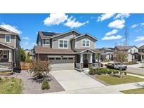 Beautiful two-story home with a well-maintained lawn, solar panels, and two-car garage at 26385 E Canal Pl, Aurora, CO 80018